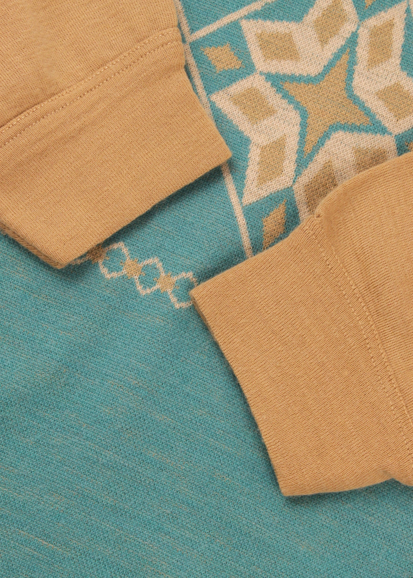 Woolen jumper in sand and blue